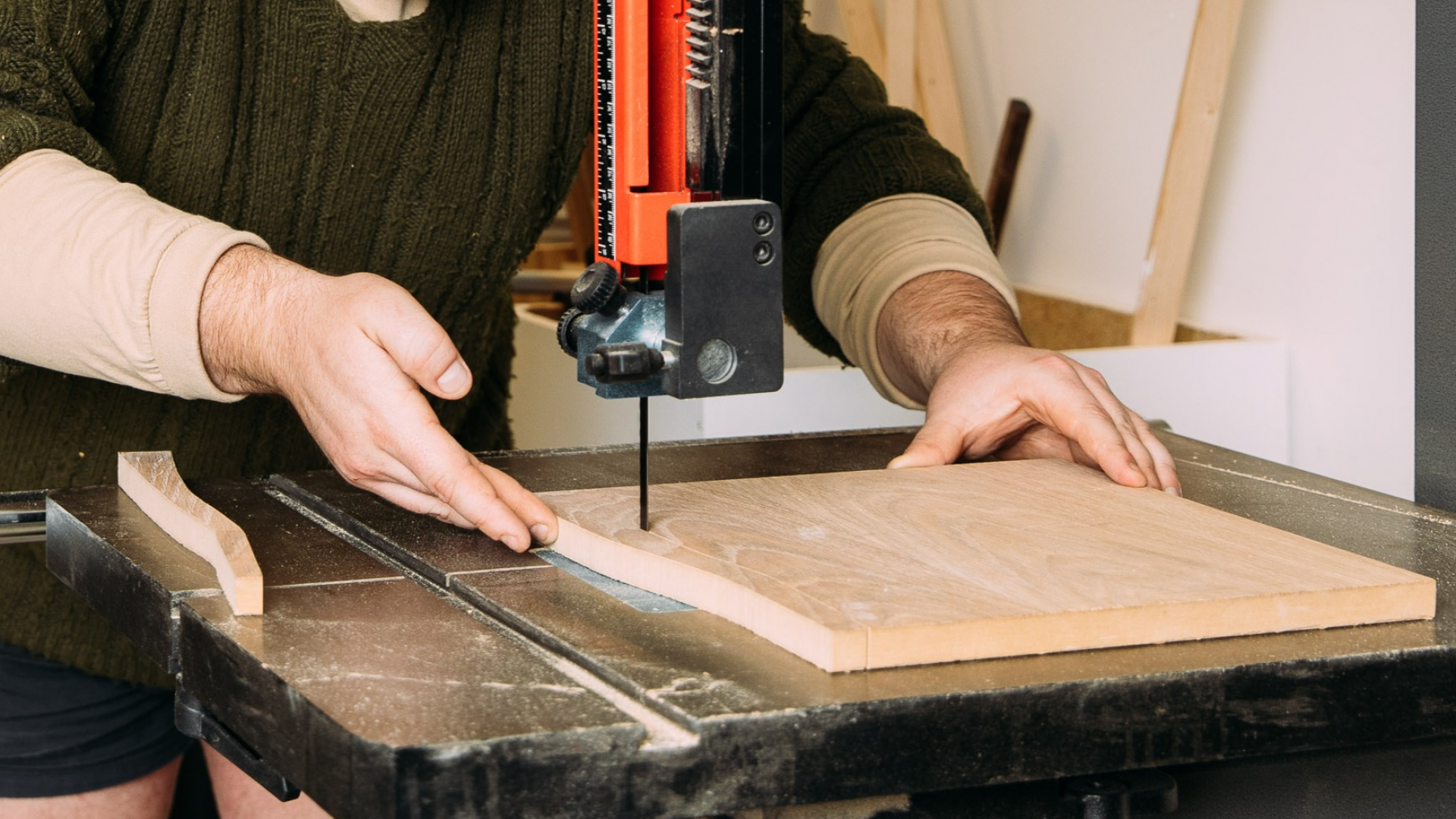 Photo of a JamFactory furniture maker cutting timber sheets to size on a bandsaw
