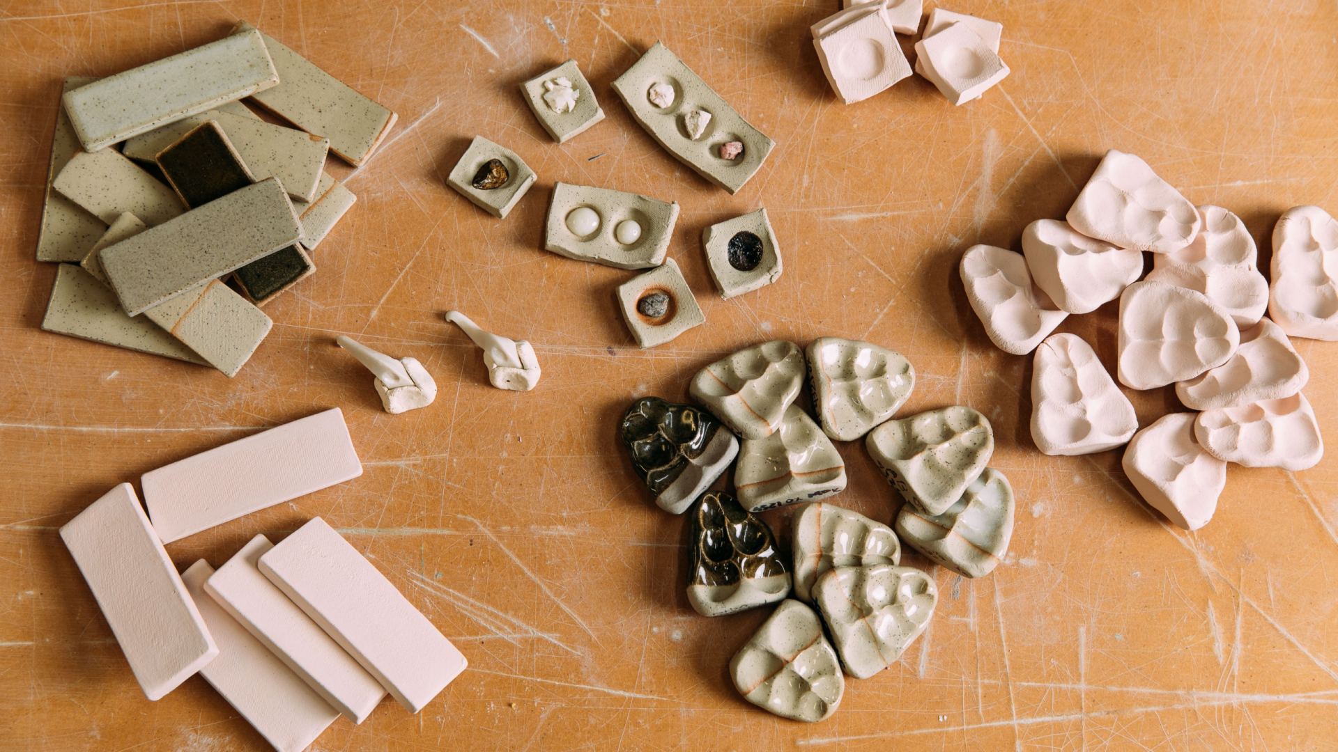 Photo of piles of test tiles in the JamFactory Ceramic Studio