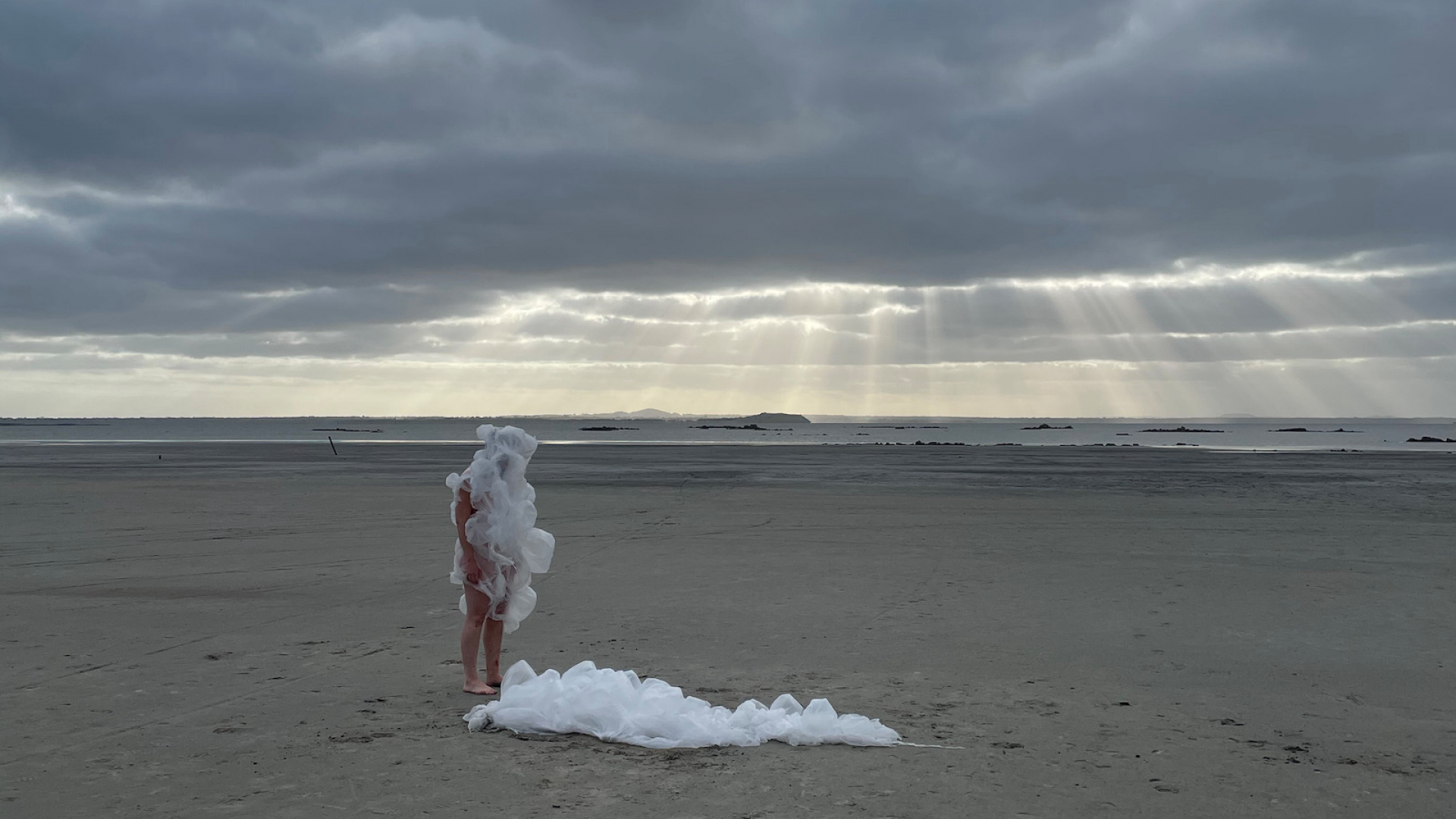 Image of performance artist and sculpture on a salt lake