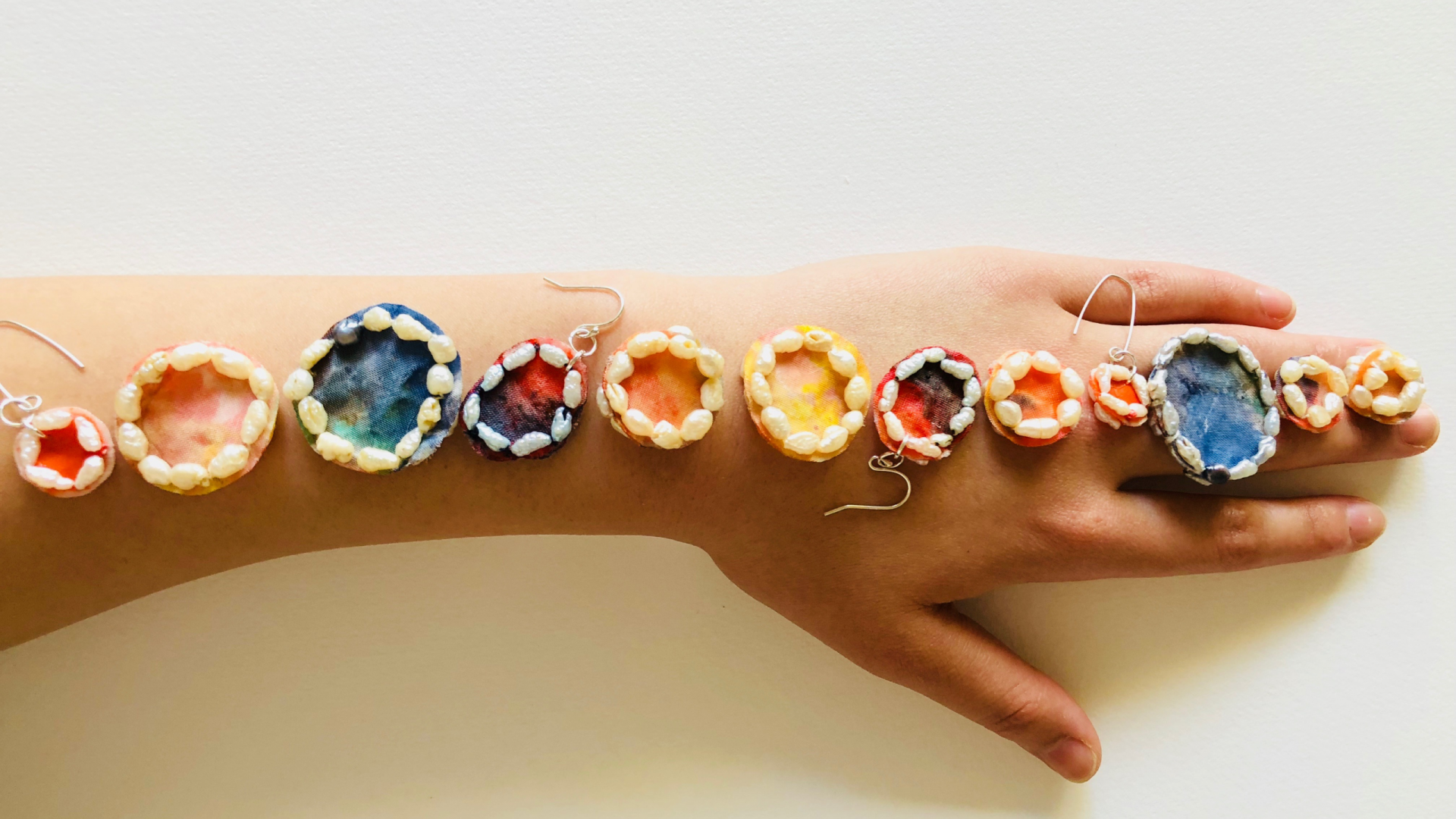 An arm with various jewellery adornments made with rice paper