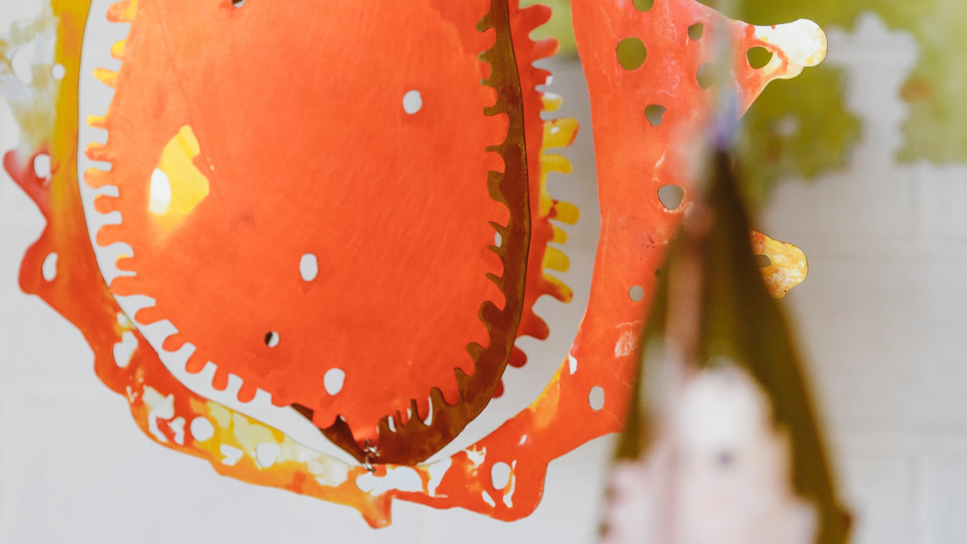 Colourful metal wall sculptures, images of seeds and lichen and nature forms