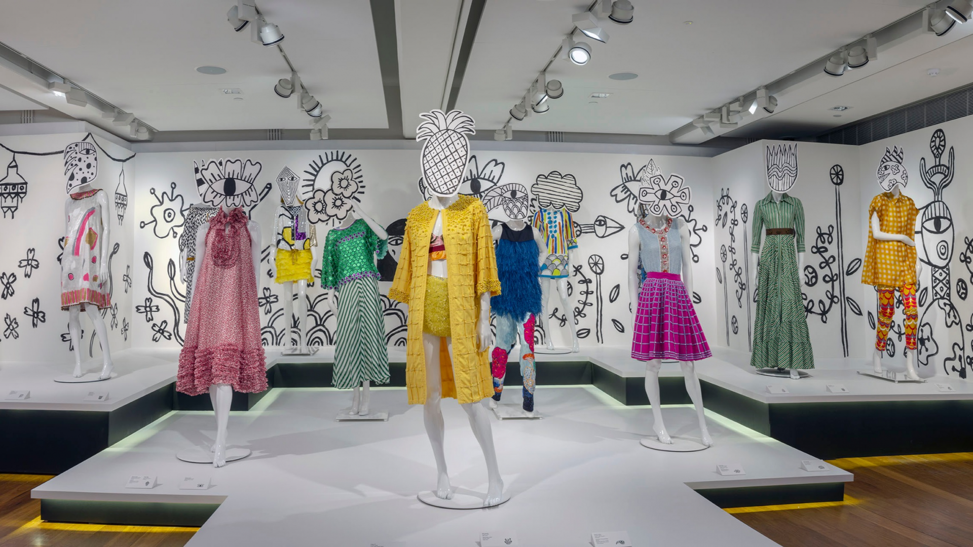 Installation view of East Pearson Archive exhibition. 10 white female mannequins are dressed in various outfits designed by Easton Pearson