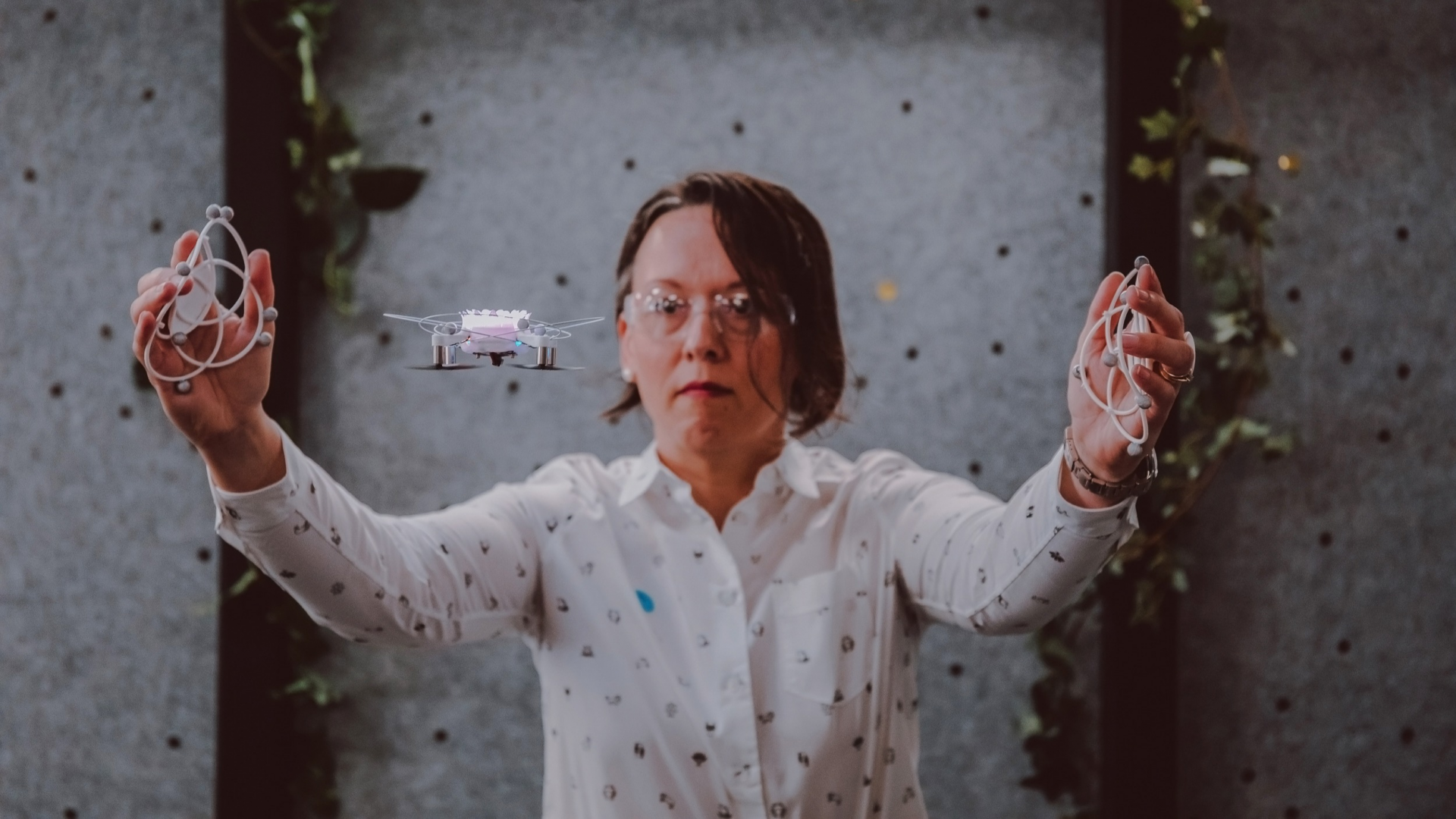 Photo of a woman moving with & operating a drone