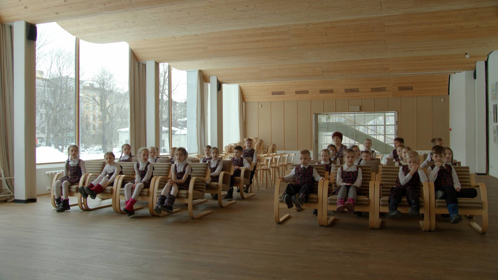 A photo of children sitting in a modernist library